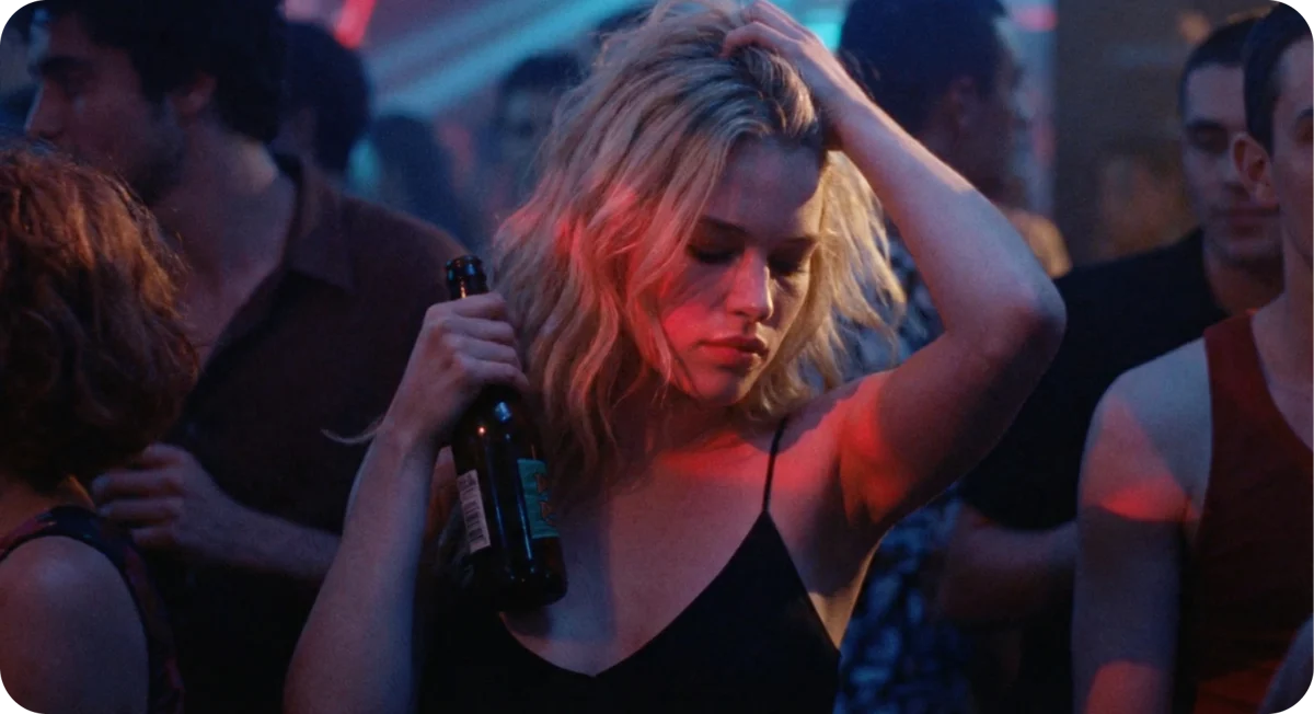 Crowded nightlife scene lit in red neon