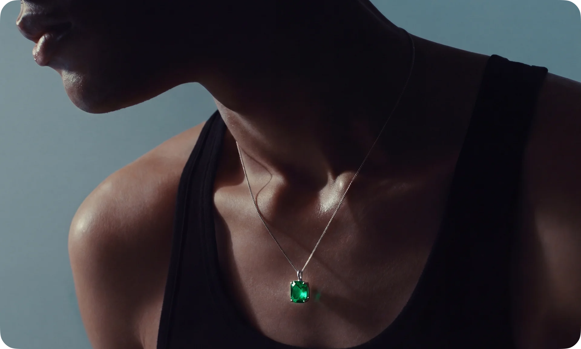 Close-up of a shoulder with a necklace in dramatic light