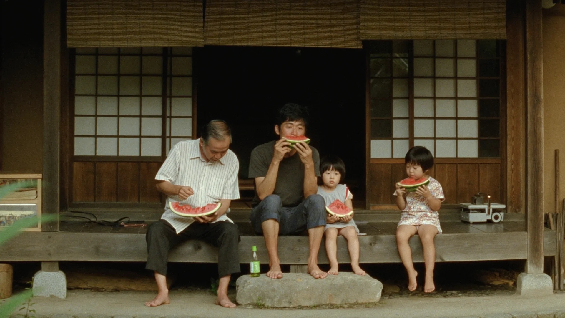 Family sitting on a porch in warm summer light
