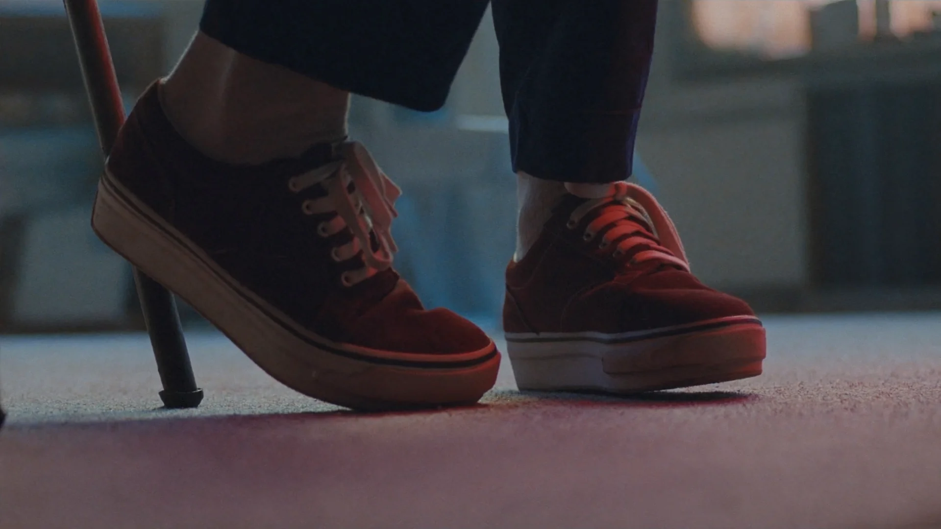 Close-up of shoes mid-step on a wet sidewalk