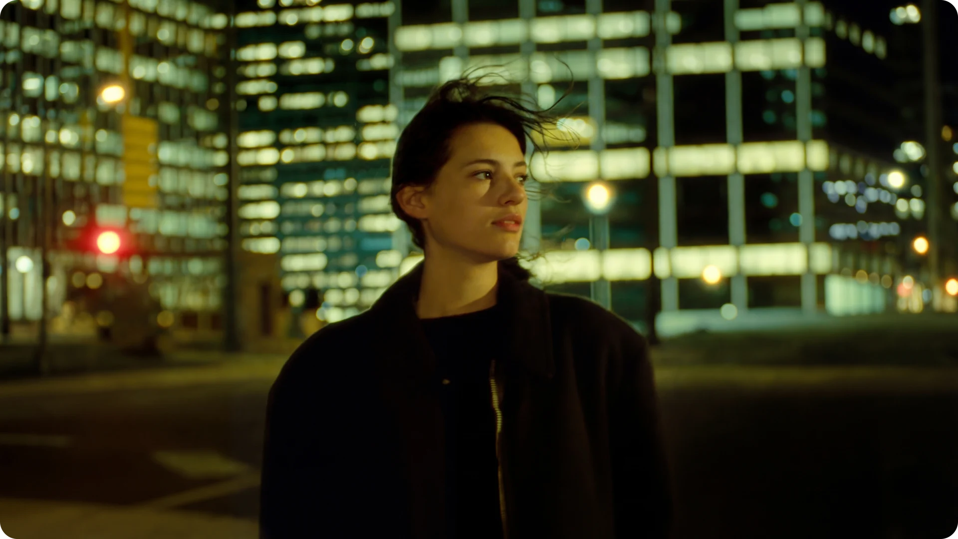 Night exterior of a person in a neon-lit city street
