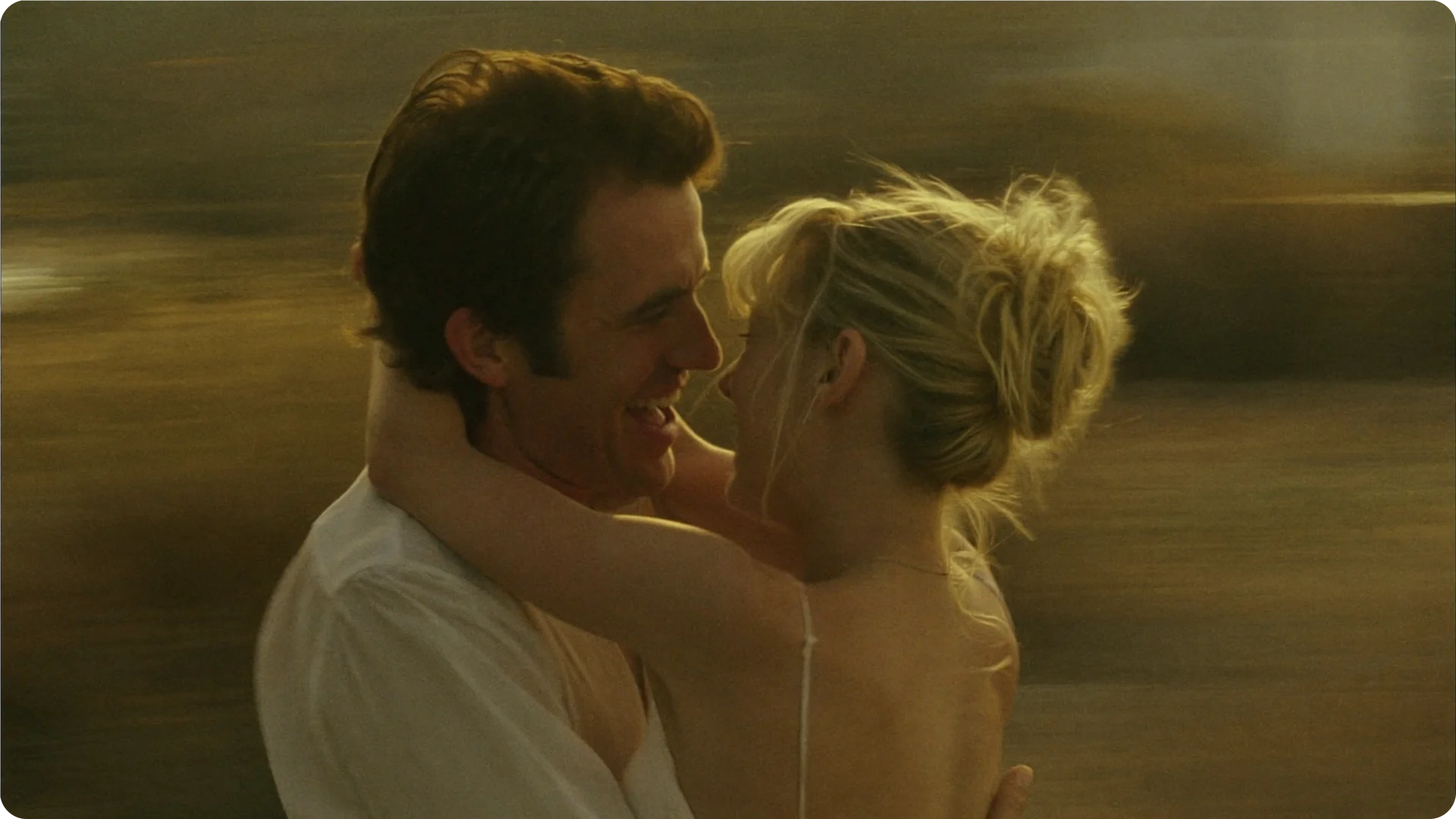 Two people holding each other in warm evening light